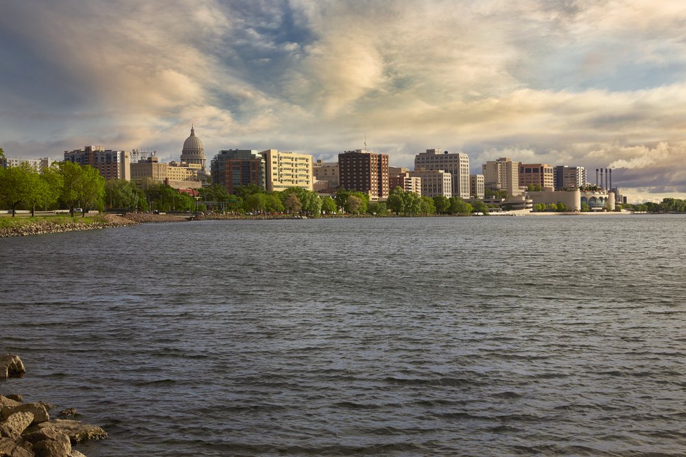 Photo of a lake with the Madison skyline in the background.